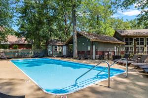 a large swimming pool in front of a house at Lodged in the Trees in New Buffalo
