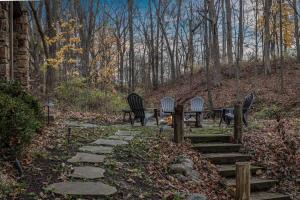 a group of chairs and a table in the woods at Lodged in the Trees in New Buffalo