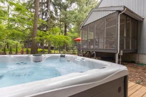 a large hot tub in front of a house at La Maison du Lac in Sawyer