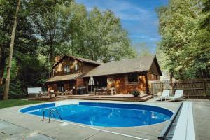 a house with a swimming pool in front of a house at Loma House in Sawyer