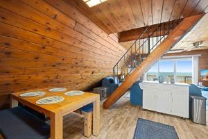 a wooden room with a table and a staircase at Leilas Chalet in Stevensville