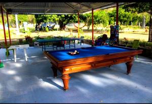 a pool table sitting on top of a patio at Posada la Melosa in Guataquí