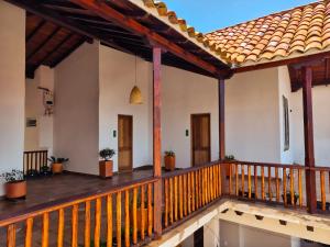 a porch of a house with a wooden deck at Casa Hotel Serena in Guadalupe