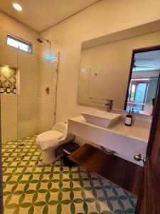 a bathroom with a large sink and a shower at Casa Hotel Serena in Guadalupe