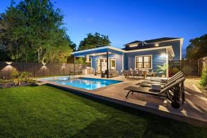 a house with a swimming pool in a yard at Stylish Southern Home with Heated Pool in Austin