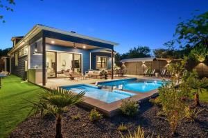 a house with a swimming pool in a yard at Stylish Southern Home with Heated Pool in Austin