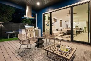 a patio with chairs and a table on a deck at Stylish Southern Home with Heated Pool in Austin +27 photos