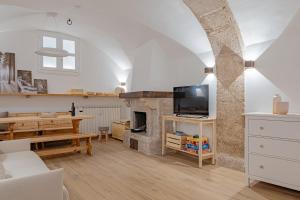 a living room with a fireplace and a dining room at Casa Caniglia 34 - YourPlace Abruzzo in Rivisondoli +18 photos