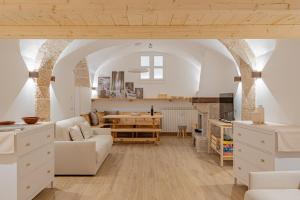 a living room with a white couch and a table at Casa Caniglia 34 - YourPlace Abruzzo in Rivisondoli