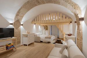 a large room with two beds and a living room at Casa Caniglia 34 - YourPlace Abruzzo in Rivisondoli