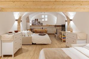 a large bedroom with two beds and a table at Casa Caniglia 34 - YourPlace Abruzzo in Rivisondoli