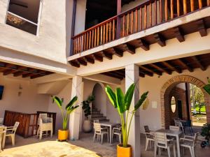 a patio with tables and chairs and a balcony at Casa Hotel Serena in Guadalupe