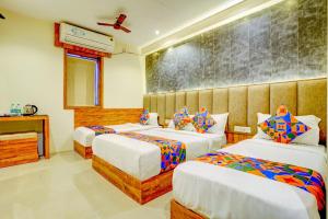 a hotel room with two beds in a room at Hotel Indore Palace Nagpada in Mumbai