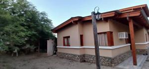 a house with a street light in front of it at Cabañas Termales in Termas de Río Hondo