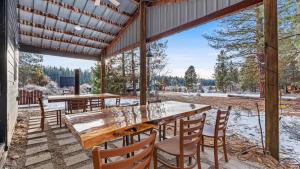 a wooden table and chairs on a patio with snow on the ground at Yurt 2 - The Gold Miner in Idaho City