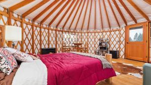 a bedroom with a bed in a yurt at Yurt 2 - The Gold Miner in Idaho City +7 photos