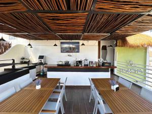 a restaurant with two wooden tables and a counter at BORÉNA Hotel Boutique in Playa del Carmen