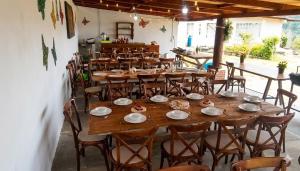 a large wooden table and chairs in a restaurant at Hotel DE LAS MARIPOSAS in Valle de Bravo