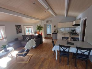 a living room with a table and a kitchen at Vue sur Ourthe in Durbuy