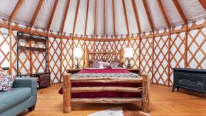a bedroom with a bed and a couch in a yurt at Yurt 2 - The Gold Miner in Idaho City