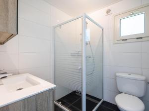 a bathroom with a shower and a toilet and a sink at Sluisje 15 in Kuinre