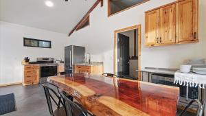 a large kitchen with a wooden table and chairs at Yurt 2 - The Gold Miner in Idaho City