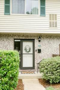a front door of a house with a wreath on it at Perfect Small Family Beach Condo in Saint Simons Island