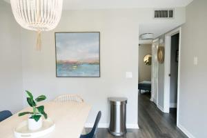 a dining room with a table and a chandelier at Perfect Small Family Beach Condo in Saint Simons Island