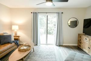 a living room with a couch and a table at Perfect Small Family Beach Condo in Saint Simons Island