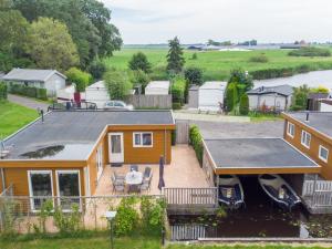 an aerial view of a house with a boat at Sluisje 15 in Kuinre