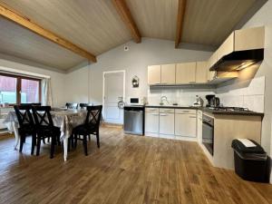 a kitchen and dining room with a table and chairs at Vue sur Ourthe in Durbuy