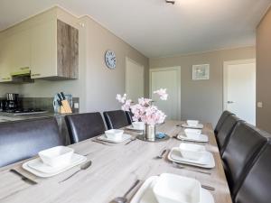 a dining room with a wooden table with black chairs at Sluisje 15 in Kuinre +16 photos