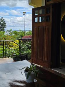 an open door to a balcony with potted plants at Aivilo Home in Entebbe