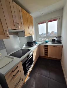 a kitchen with a sink and a stove top oven at Paris-Alfortville in Alfortville +3 photos