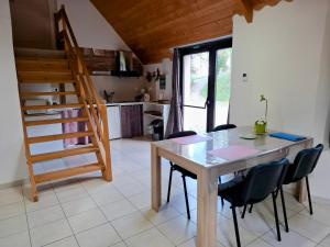 a kitchen and dining room with a table and chairs at La ferme de la Cavalerie in Saint-Gonnery