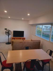 a living room with a couch and a table at Bernal Alquileres in Viedma
