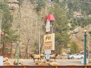a hotel sign with a clock on top of it at Nicky's Resort in Estes Park