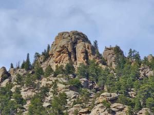 a rocky mountain with trees on top of it at Nicky's Resort in Estes Park