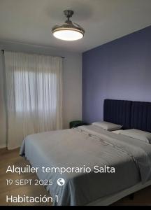 a bedroom with a large bed and a window at Casa Paradiso Salta in Salta