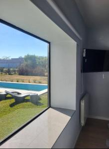 a room with a window with a view of a pool at Casa Paradiso Salta in Salta