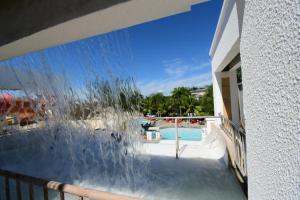 a view of a swimming pool from the balcony of a house at Lacqua diRoma 1 - Apartamentos JN in Caldas Novas