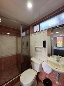 a bathroom with a toilet and a sink at Hostelfc Movistar57 in Bogotá +49 photos
