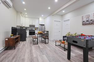 a large kitchen with tables and chairs in a room at Cozy stays in Montreal