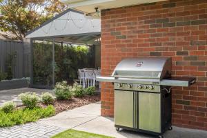 a barbecue grill sitting outside of a house at Ohana Coastal Escape in Rosebud