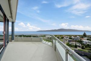 a balcony with a view of the ocean at U Suites at The Links in Paraparaumu