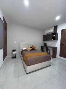 a bedroom with a bed in a white room at Casa Cerritos in Comitán