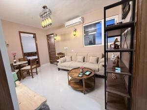 a living room with a couch and a table at Skypod13 in Chandīgarh