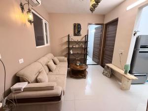 a living room with a couch and a tv at Skypod13 in Chandīgarh