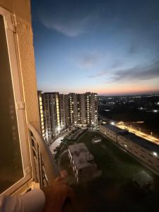 a person is looking out the window of a building at Skypod13 in Chandīgarh