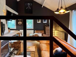 a living room with a couch and a table at Cozy Durbuy Chalet with fireplace in Dochamps